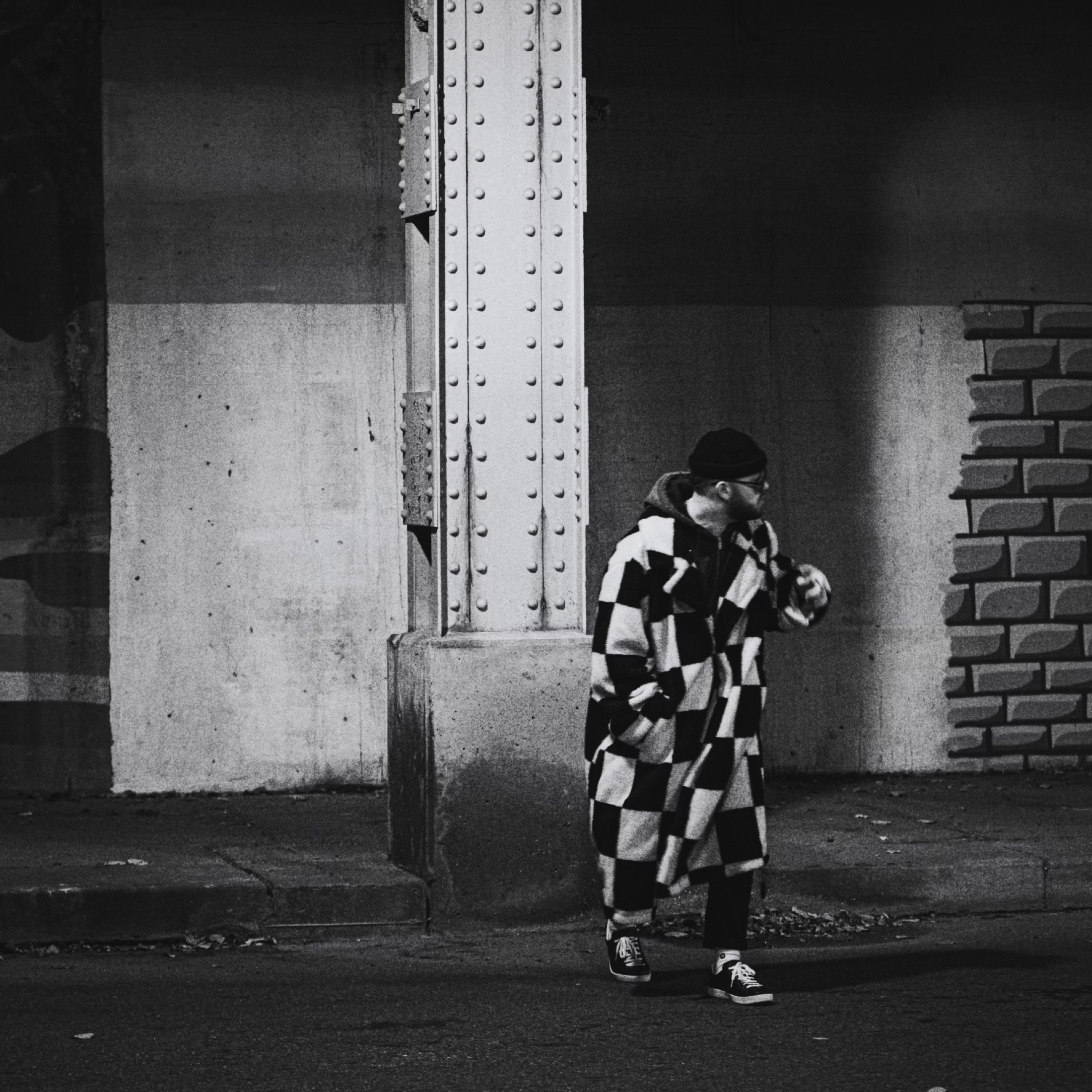 Tyler Schwenk walking under a bridge at night